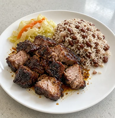 Jerk pork with rice and peas and cabbage